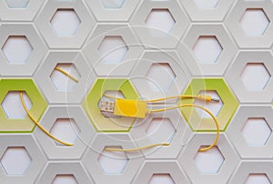 Yellow cable USB on white and green honeycomb background