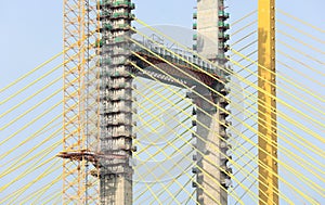 Yellow cables of under construction suspension bridge