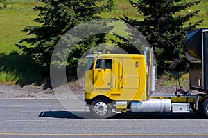 Yellow cabover big rig semi truck old model on road