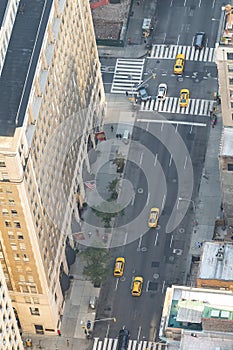 Yellow cabs traffic along a major Manhattan Avenue, overhead aerial view, New York City, USA