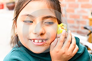 Yellow canary in the hands of a girl. bald little bird. care tenderness protection.