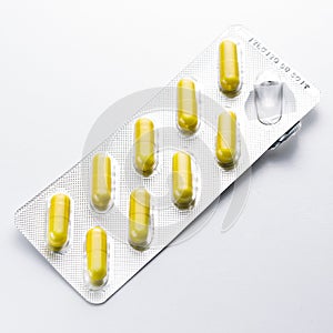 Yellow capsule Tablets pills in a Blister packaging doctor antibiotic pharmacy medicine medical