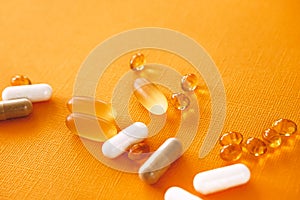 Yellow capsules of nutraceuticals in spoon. Pills and meds. photo