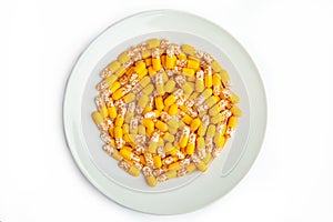 Yellow capsules on a white plate