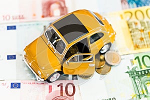 Yellow car with money on background