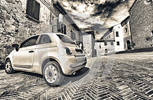 Yellow car parked in a old medieval italian town