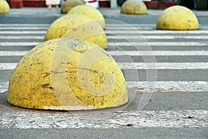 Yellow car parking barriers on zebra crossing