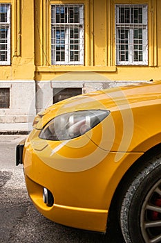 Yellow car on Yellow Wall