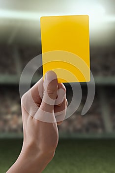 Yellow card with hand from referee giving a penalt
