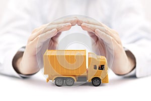 Yellow cargo delivery truck protected by hands