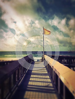 Yellow caution beach flag at Navarre Beach, Florida.