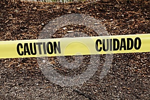 Yellow Caution Cuidado Ribbon On Side Of Road photo