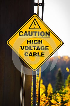 A yellow Caution High Voltage Cable sign