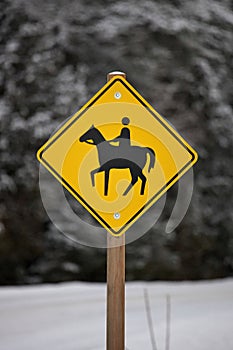 Yellow Caution Horse Riding Sign in a Rural Setting in Winter