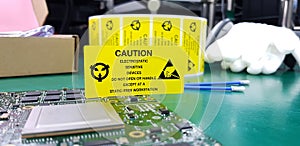 The yellow CAUTION label for Electrostatic Sensitive Devices ESD on static free workstation photo