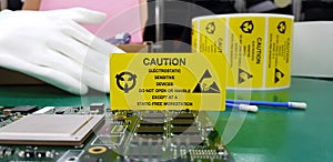 The yellow CAUTION label for Electrostatic Sensitive Devices ESD on static free workstation