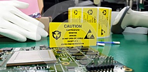 The yellow CAUTION label for Electrostatic Sensitive Devices ESD on static free workstation