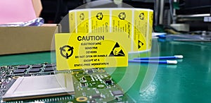 The yellow CAUTION label for Electrostatic Sensitive Devices ESD on static free workstation