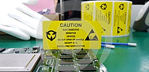 The yellow CAUTION label for Electrostatic Sensitive Devices ESD on static free workstation