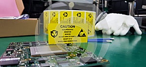 The yellow CAUTION label for Electrostatic Sensitive Devices ESD on static free workstation photo