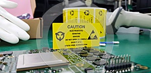 The yellow CAUTION label for Electrostatic Sensitive Devices ESD on static free workstation