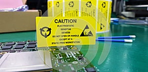 The yellow CAUTION label for Electrostatic Sensitive Devices ESD on static free workstation photo