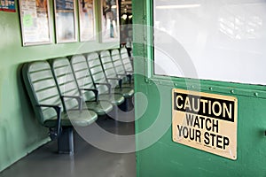 Yellow caution sign on a green door