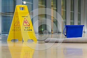 The yellow caution sign showing warning of slippery wet floor