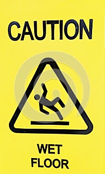 A yellow caution sign showing wet floor