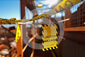 Yellow caution sign/ symbols tag applying on the entry construction workplace to ensure safety warning precaution in place