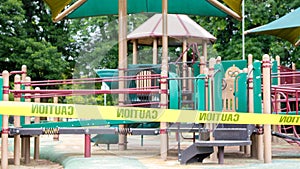 Yellow caution tape blocking off a colorful playground during lockdown