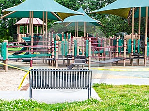 Yellow caution tape blocking off a colorful playground during lockdown