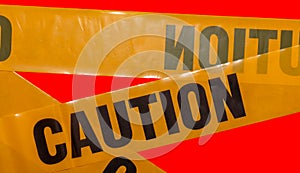 Yellow caution tapes crossing. Isolated. Red background