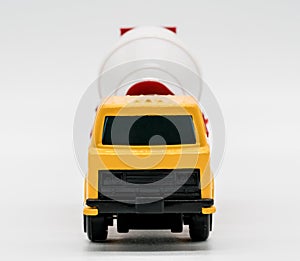 Yellow cement mixer truck toy isolated on white