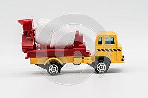 Yellow cement mixer truck toy isolated on white