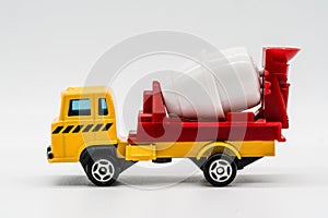 Yellow cement mixer truck toy isolated on white