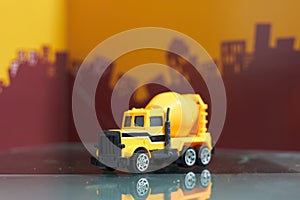 Yellow cement truck on blur city background,selective focus