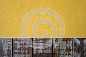 Yellow cement walls and pastel wood planks texture background