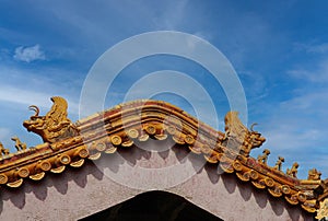 Yellow ceramic  dragons as decoration on a roof in china