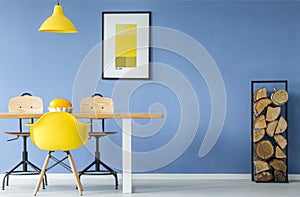 Yellow chair and hanging lamp