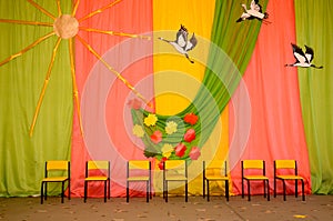 Yellow chairs in kindergarten. Matinee room, autumn