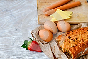 yellow Cheese, strawberry, bread and eggs