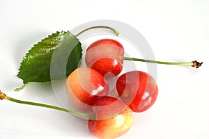 Yellow cherry fruits on a white background.