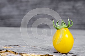 Yellow cherry tomato on wood background