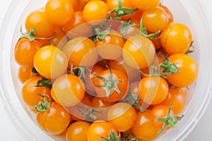 Yellow cherry tomatoes in the container