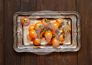 Yellow cherry tomatoes on a metal tray