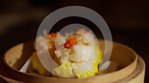 Yellow Chinese dim sum adorned with succulent ebi shrimp on top. These delectable morsels showcase the perfect fusion of