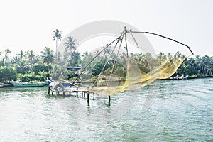 Yellow Chinese fisher net along the kollam kottapuram waterway photo