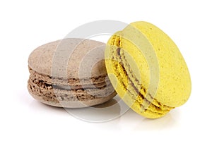 Yellow and chocolate macaroon isolated on white background closeup