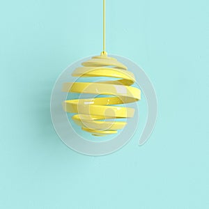 Yellow Christmas ornament on light blue background